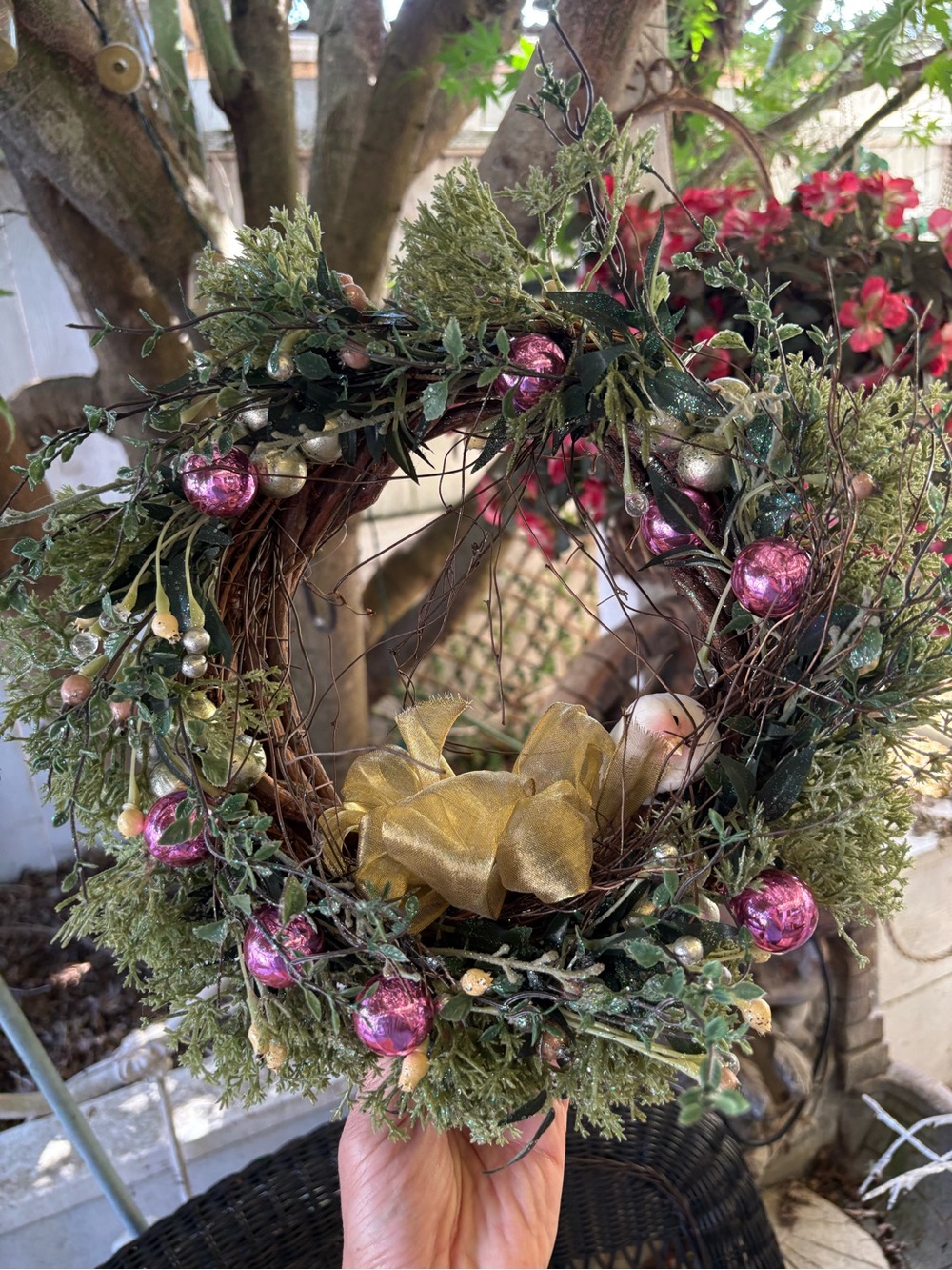 Decorative Holiday Wreath with Pink Ornaments and Gold Bow